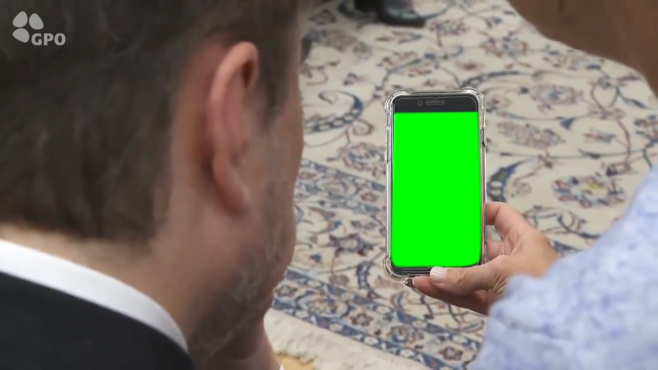 Elon Musk watching a video on a phone (Green Screen)