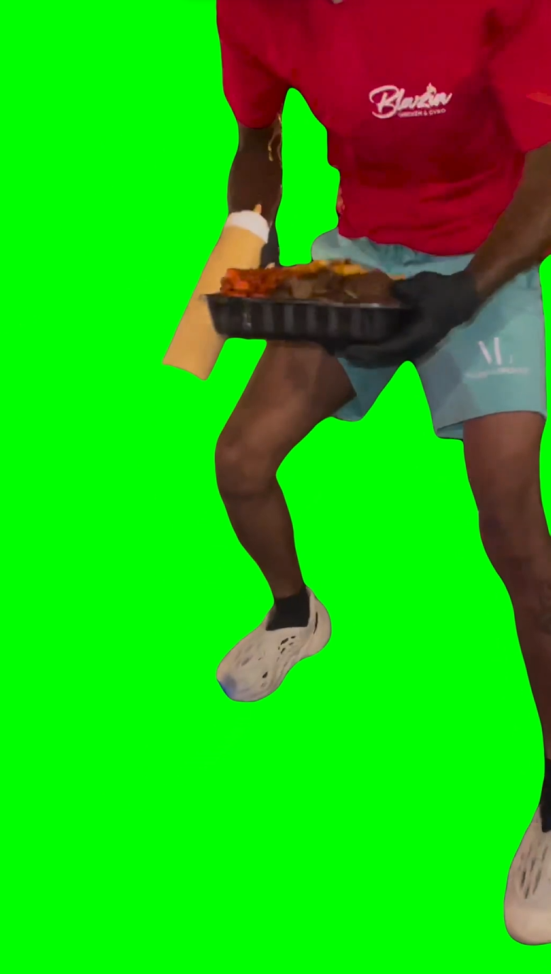 Man showing off food while standing on moving bike (Green Screen)