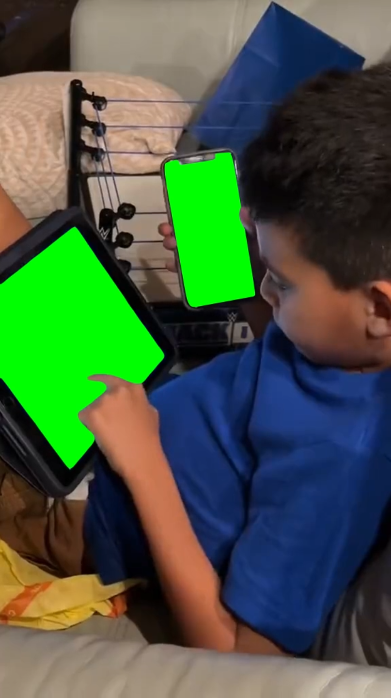 Kid using iPad and iPhone at the same time (Green Screen)